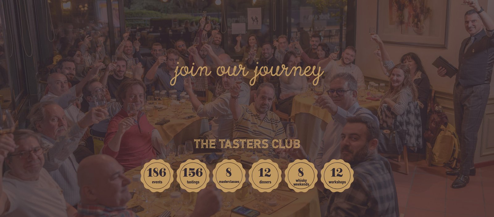 members of The Tasters Club toasting with a glass of whisky